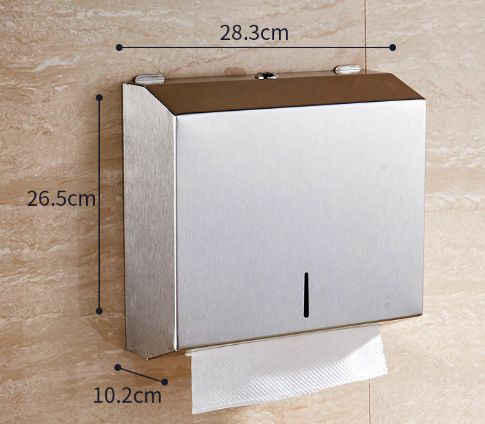 Wall-mounted paper towel holder with dimensions on a beige tiled wall
